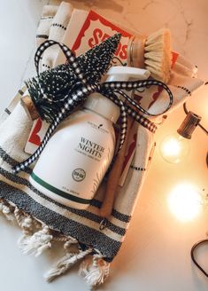 a bottle of body lotion sitting on top of a towel next to a light