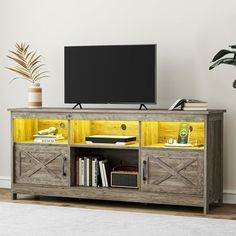 an entertainment center with a flat screen tv on top