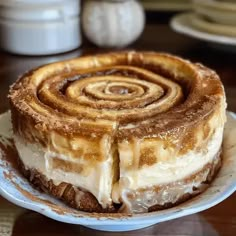 a cinnamon roll cake sitting on top of a white plate