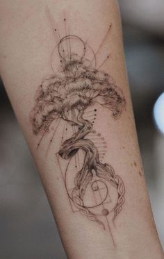 a woman's arm with a tree tattoo on it