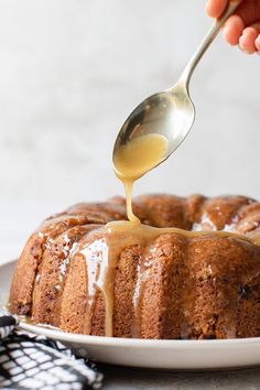 someone drizzling caramel sauce onto a bundt cake on a plate