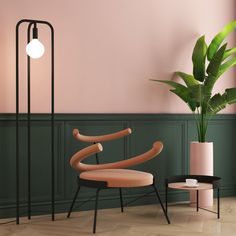 a chair and table in a room with pink walls, green plant and floor lamp