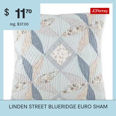 a blue and white pillow with an image of a pattern on the front, which reads linden