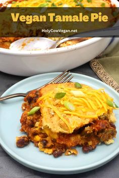 a casserole dish on a blue plate with a fork in it and the text vegan tamale pie