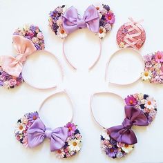 six minnie mouse ears with purple bows and flowers on them are arranged in the shape of a circle