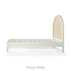 a white bed with an arch shaped headboard and foot board on the bottom side