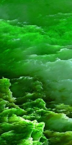 an abstract photo of green water and clouds