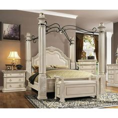 a white bed sitting on top of a wooden floor next to a dresser and mirror