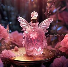 a pink perfume bottle sitting on top of a table