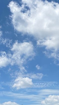 the sky is filled with white fluffy clouds