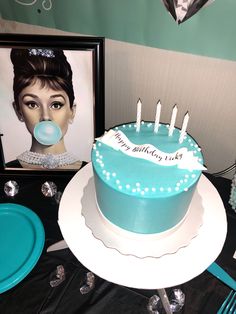 a blue birthday cake sitting on top of a table