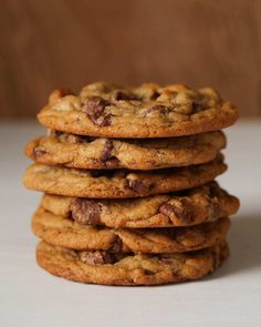 a stack of chocolate chip cookies sitting on top of a table