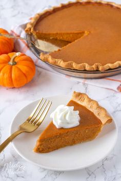 a slice of pumpkin pie on a plate with a fork