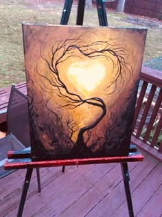 an easel with a heart shaped painting on it