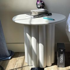 a white table with some books on it