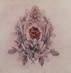 a rose tattoo on the back of a woman's shoulder