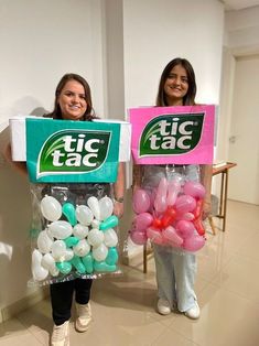 two girls are holding up boxes with balloons in them and one has a sign that says tic tac