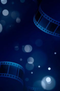 a film strip with blurry lights and circles around it on a dark blue background