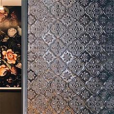 an intricately designed metal door with flowers on the front and side panels in silver