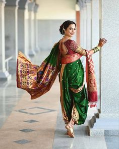 a woman in a green and red sari