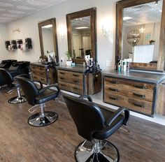 a hair salon with chairs and mirrors on the wall next to it's wooden floor