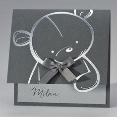 a black and white card with a teddy bear on it's side, that says mia