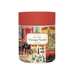 the new york city skyline puzzle canister is shown in an orange and red tin