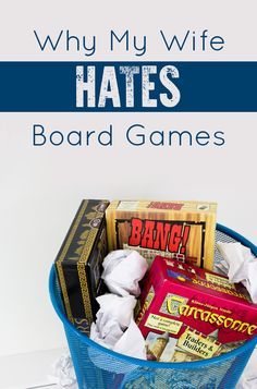 a blue basket filled with different types of games and snacks on top of a white table