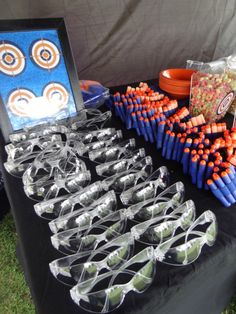 an assortment of sunglasses and other items on display at a party or outdoor event in the grass