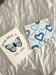 two pieces of paper with blue and white designs on them, one has a butterfly