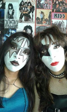 two women with face paint and makeup are posing for a photo in front of a wall