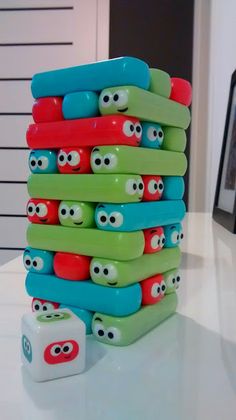 a stack of toothbrush holders sitting on top of a white table next to a box