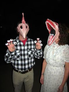 two people wearing masks with their mouths open and one person holding something in front of them