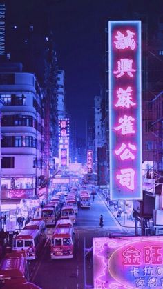 a city street filled with lots of neon signs and cars parked on the side of it