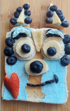 a cake made to look like a face with blueberries on it