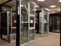 an empty room with several glass doors and some signs on the door frames in front of them