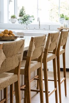 there are many chairs around the table in this kitchen