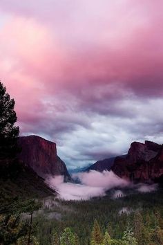 an image of the mountains and clouds with arabic writing on it in front of a cloudy sky