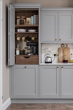 a kitchen with gray cabinets and white counter tops