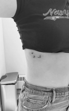 a woman's stomach with small birds on her side and the word never above it