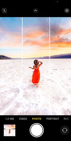 a woman in an orange dress is standing on the beach