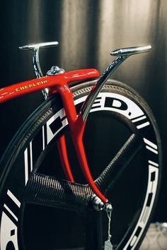 a close up of a red bicycle with black and white decals