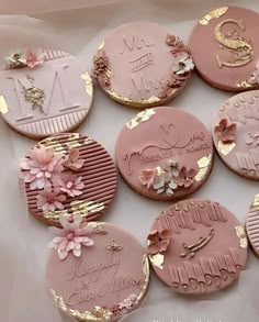 pink and gold decorated cookies with flowers on them