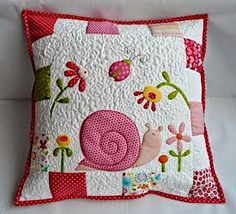 a pillow with a snail and flowers on it