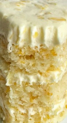 two pieces of cake sitting on top of a white plate covered in frosted icing