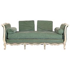 a green couch sitting on top of a white floor