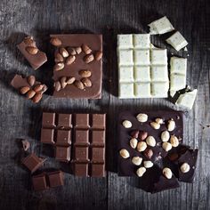 chocolate bars, nuts and almonds on a wooden table