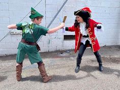 two children dressed in costumes playing with swords