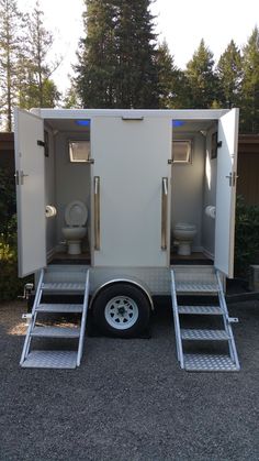 a toilet trailer with stairs leading up to it's doors and toilets in the back