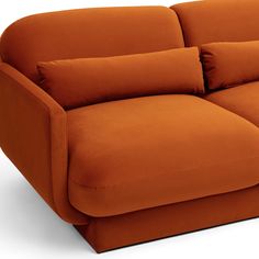 an orange couch sitting on top of a white floor